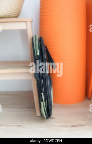 Portable Pop-Up Pet Carrier with Mesh Panels in Modern Home Interior. A collapsible olive green and black mesh pet carrier sits open on a light wooden Stock Photo