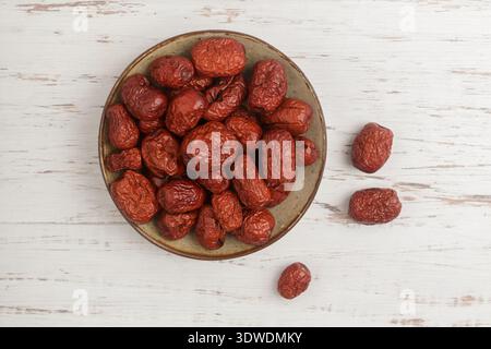A plate with dried ziziphus (Chinese date) on the table. Jojoba. Selective focus Stock Photo