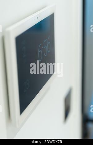 A digital interface mounted on the wall of a contemporary London home, showcasing the integration of smart home technology in urban residential interi Stock Photo