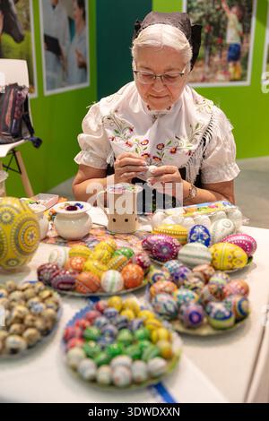 BERLIN, GERMANY, January 16th 2026: Photo of A Sorbian woman is decorating Easter eggs at the Internationale Grüne Woche trade fair in Berlin Germany Stock Photo