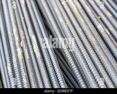 Close-up image of sturdy steel rebar used for reinforcing concrete structures, essential in construction projects for added strength and stability in Stock Photo