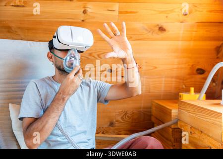A person explores virtual reality beekeeping while wearing a virtual reality headset and an oxygen mask. This innovative approach enhances wellness by Stock Photo