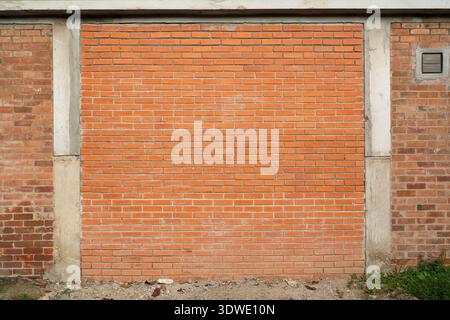 Orange brick wall with concrete columns Stock Photo