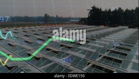Spanning large solar panels on metal racks at rural farm from drone view, showing data overlay Stock Photo