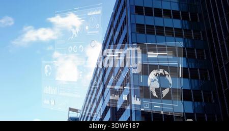 Displaying glass tower rising in city, showing window grid, HUD with globe charts Stock Photo