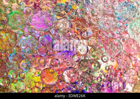 A mesmerizing view of colorful bubbles forming an intricate pattern of light reflections, capturing the vivid spectrum in a microscopic journey into t Stock Photo