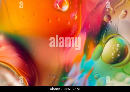 Dive into an abstract world of swirling liquid colors. This vibrant display features spheres and gradients of orange, pink, green, and blue, blending Stock Photo