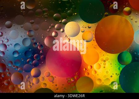 A mesmerizing display of colorful bubbles against a dark background, showcasing a vibrant spectrum of hues. Journey into a captivating realm of abstra Stock Photo