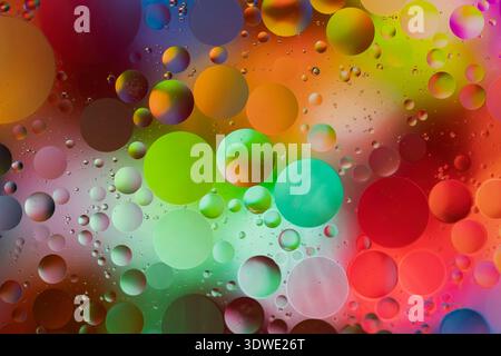 Vivid spheres of various sizes float across a vibrant spectrum of colors. Light reflections create a mesmerizing, abstract journey into the realm of c Stock Photo