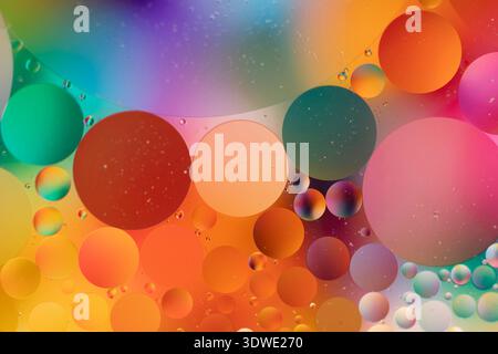 A stunning abstract image featuring vibrant spheres in shades of orange, red, pink, and green. The colorful backdrop creates a dynamic interplay of hu Stock Photo