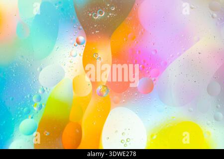 Dive into a world of vivid colors and abstract spheres in this image, showcasing a mesmerizing blend of blues, pinks, oranges, and yellows in a dynami Stock Photo