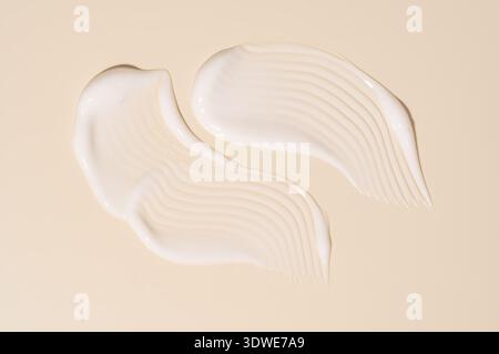 Close-up view of a smooth, creamy gel with delicate ripples creating a textured design. The soft, wavy pattern enhances the visual appeal on a neutral Stock Photo