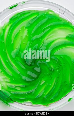 Close-up image of a vibrant green aloe vera gel with visible bubbles, showcasing its smooth, rich texture. Ideal for showcasing skincare products and Stock Photo