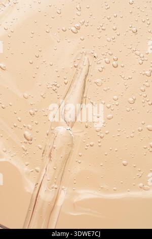 Clear gel texture with numerous small air bubbles, creating an abstract pattern. The smooth, undulating surface highlights a translucent quality and s Stock Photo