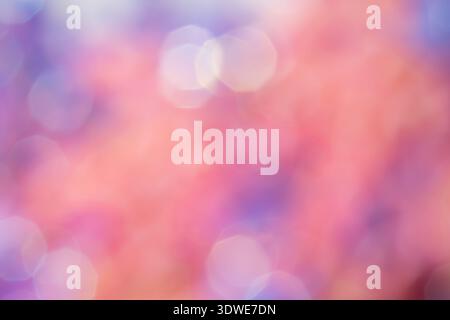 Defocused bokeh abstract background featuring a serene blend of pastel colors like pink and purple, creating an elegant, soft, ethereal visual effect. Stock Photo