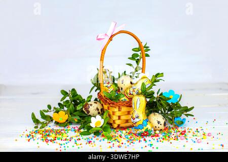 Easter composition. decorated with Easter bread and Easter eggs on the table decorated with herbs and chocolate hare Stock Photo