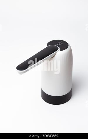 Modern white automatic soap dispenser with black lever pump and sleek curved design - hygienic touch-free solution for bathrooms, kitchens, offices, a Stock Photo