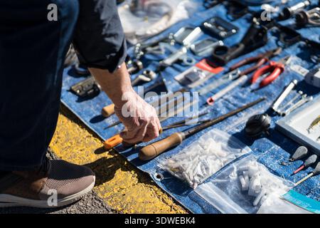 A local market scene showcasing second-hand tools and various items on display. The image captures the essence of sustainable lifestyles and community Stock Photo
