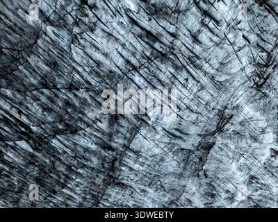 Captivating aerial view of Skaftafell Glacier, Iceland, showcasing the mesmerizing patterns and textures formed naturally on the icy surface, under na Stock Photo