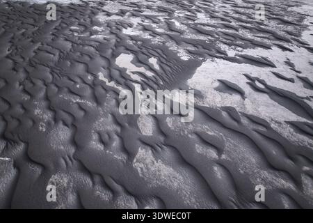 Aerial view of a stark, undulating landscape revealing intricate ...