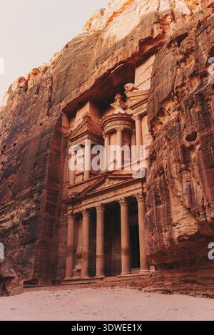 Petra's breathtaking ancient architecture in Jordan's arid desert. This archaeological marvel, carved into rose-red cliffs, boasts intricate facades a Stock Photo