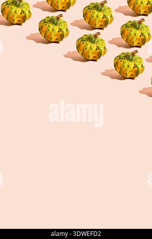 A vibrant pattern of green and yellow pumpkins set against a soft pastel background. This festive design embodies the spirit of Halloween celebration, Stock Photo