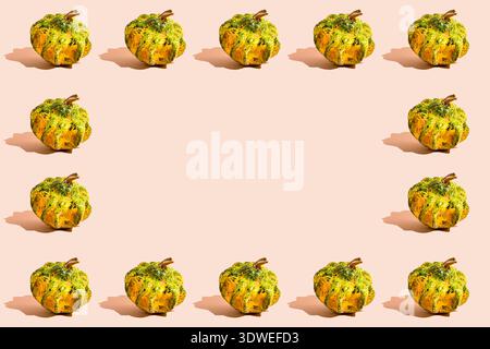 Celebrate Halloween with this vibrant pumpkin pattern on a festive background. Ideal for seasonal design, this image features symmetrical pumpkins cas Stock Photo