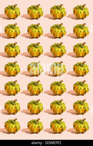 A vibrant pattern of small green and orange pumpkins on a soft background, perfect for adding a festive Halloween touch to any celebration or seasonal Stock Photo