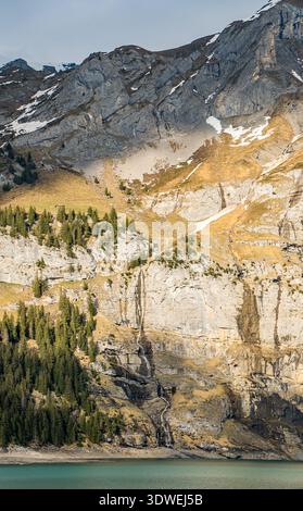 Majestic rocky cliffs and towering trees against blue sky. View from a ...