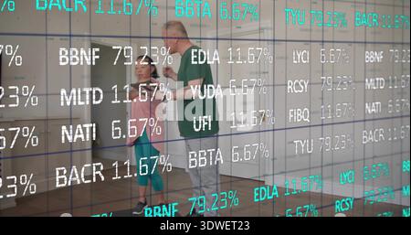 Guiding man touching woman in studio, wearing green shirt and pink top, with ticker overlay Stock Photo