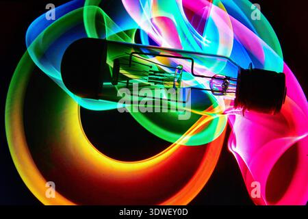 A vacuum tube or light bulb on an abstract colored pattern background. Stock Photo