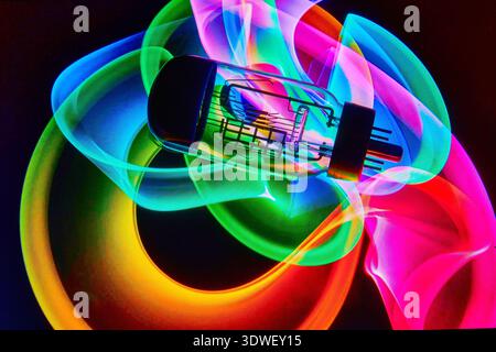 A vacuum tube or light bulb on an abstract colored pattern background. Stock Photo