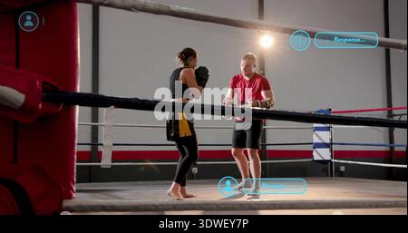 Sparring woman wearing black top yellow shorts facing man wearing red shirt inside gym ring, gloves Stock Photo