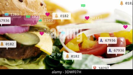 Displaying cheeseburger and fresh salad on tabletop, overlaying social media notification icons Stock Photo