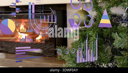 Framing Xmas tree branch with gold bauble and tinsel, burning fireplace with AR charts, copy space Stock Photo