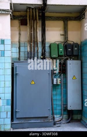 Old control cabinet by the wall. A large electrical control box of the aviaplant. Stock Photo