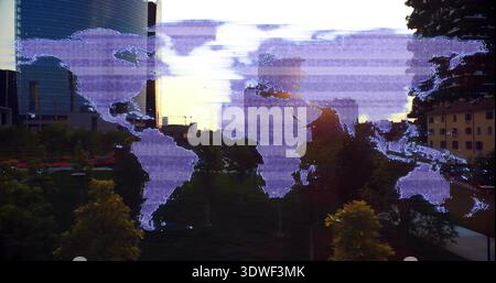 Overlaying purple world map graphic showing urban park across green lawn with scanline glitches Stock Photo