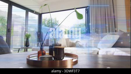 Sitting round copper tray holding dark mug, diffuser, vase on coffee table in bright living room Stock Photo