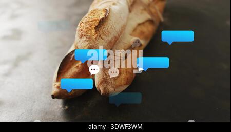Showing three crusty baguettes overlapping on slate table with blue speech bubbles and gray dots Stock Photo