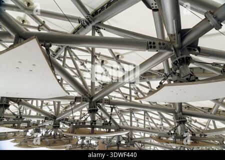 Detailed view of a sophisticated metal truss system with white acoustic baffles. High tech architectural design for large public spaces and modern sta Stock Photo