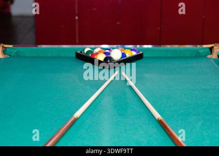 Ulyanovsk, Russia - February 11, 2022: Billiard balls, cues in the billiard room close-up. Stock Photo