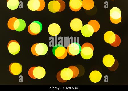Blurred lights of a garland of warm colors. Christmas textures for decoration and graphic design. Stock Photo