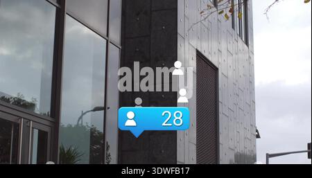 Displaying blue notification bubble showing user 28 on modern office facade, with glass reflections Stock Photo
