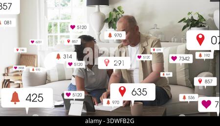 Reviewing couple in casual clothing examining documents and tablet in living room, badge icons Stock Photo