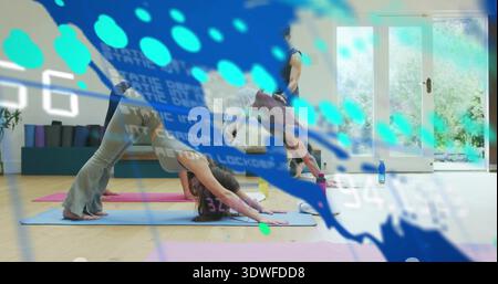 Practicing woman on blue mat doing downward dog, yoga studio, activewear, blue overlay, copy space Stock Photo
