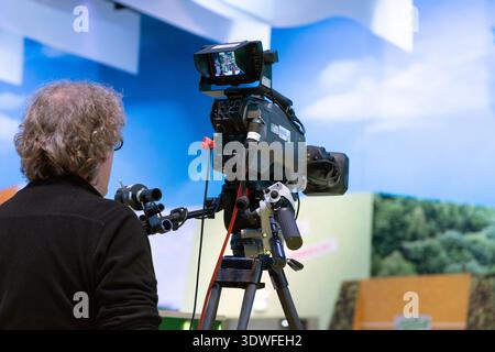 Berlin, Germany - January 22, 2024: Camera operator is filming a scene with professional equipment in a studio setting. Stock Photo