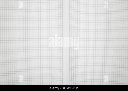 Macro shot of a black metal double-wire spiral binding on white notebook. Top view Stock Photo