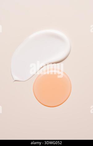 Image showcasing two cosmetic swatches on a beige background, featuring a creamy white and a soft peach tone. Perfect for highlighting skincare or mak Stock Photo