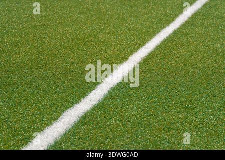Fresh green turf on a renovated soccer field showcasing a neatly painted white line, symbolizing the start of a rejuvenated sports ground ready for up Stock Photo