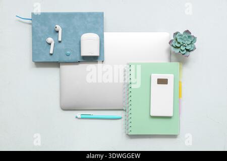Modern gadgets with notebooks on white background Stock Photo